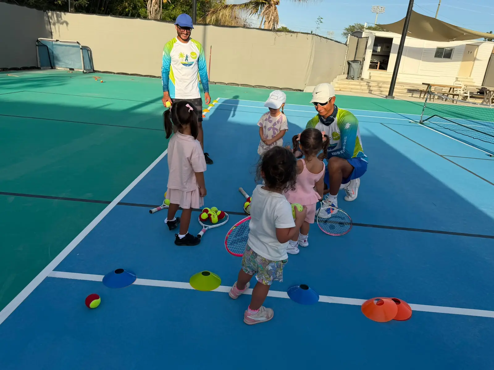 Coaches running a junior class with cones and soft balls